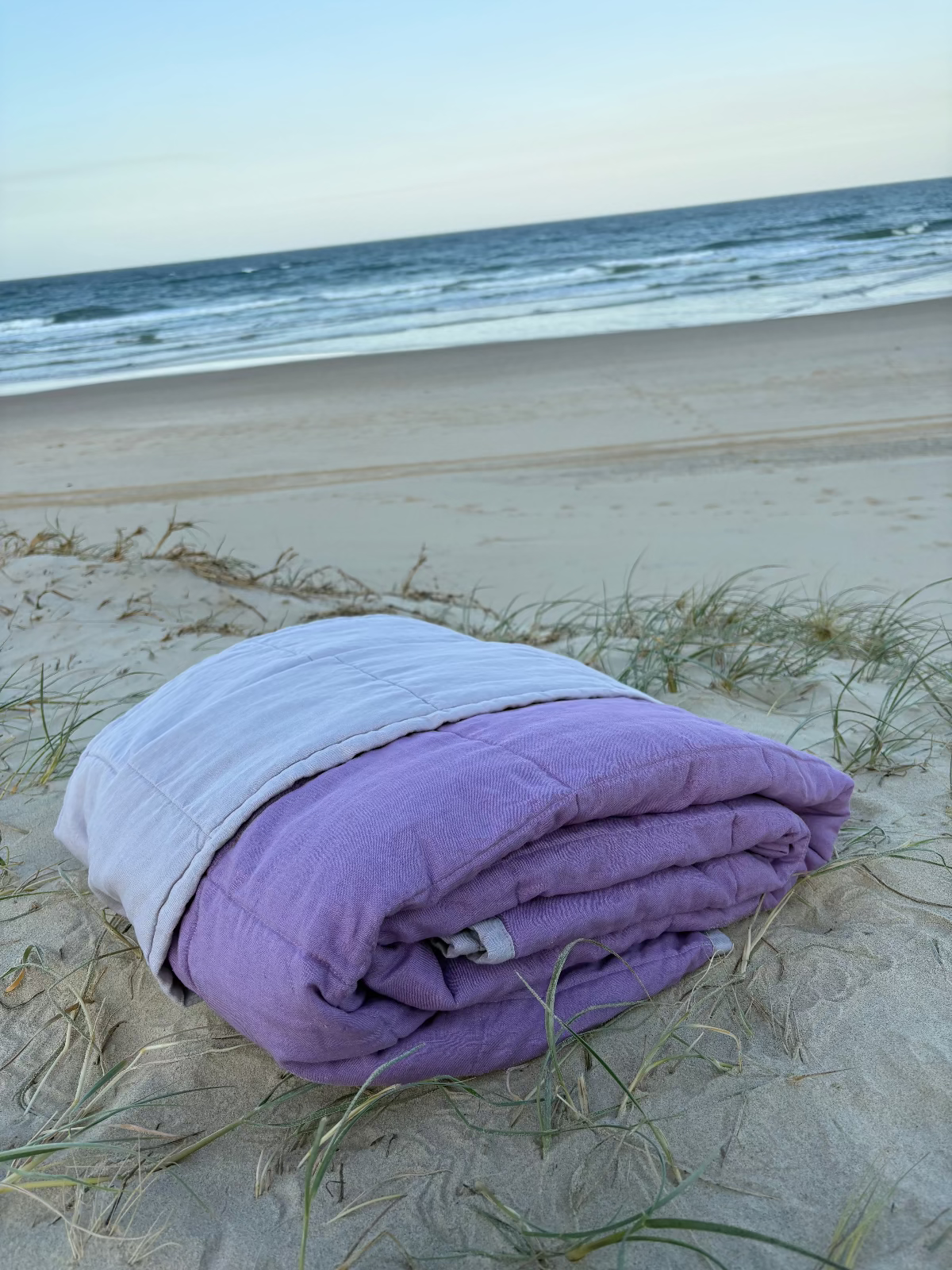 Pausa Throw folded on the beach